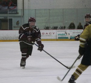 GHS 16 - Nick Nault with the puck on his stick against Portsmouth. (Photo by Charron)